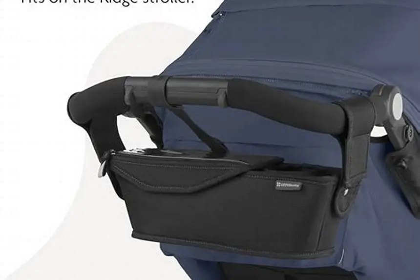 Parent console pocket on stroller handle holding phone and keys
