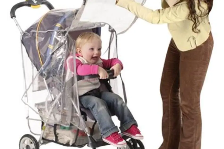 Parent measuring stroller width at wheels with tape measure